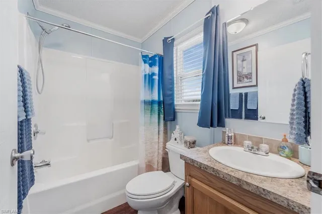 a bedroom with a bed and a flat tv screen on the dresser