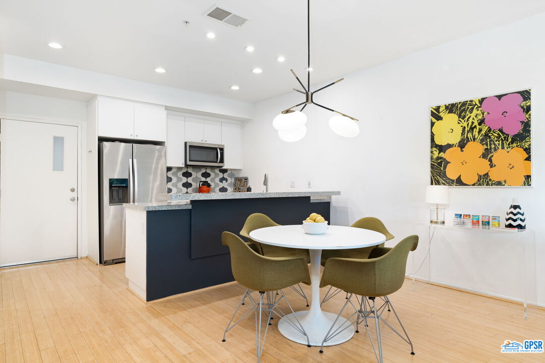 665 East Arenas Road Palm Springs, CA 92262 - Photo 11 of 40 a kitchen with a dining table and chairs