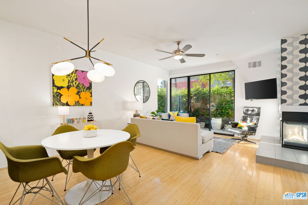 665 East Arenas Road Palm Springs, CA 92262 - Photo 12 of 40 a view of a dining room with furniture one side kitchen view and wooden floor