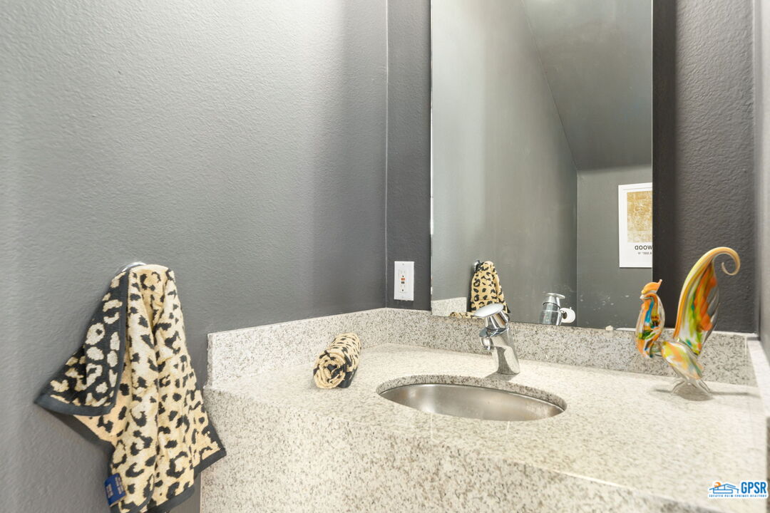 665 East Arenas Road Palm Springs, CA 92262 - Photo 16 of 40 a bathroom with a sink and a mirror