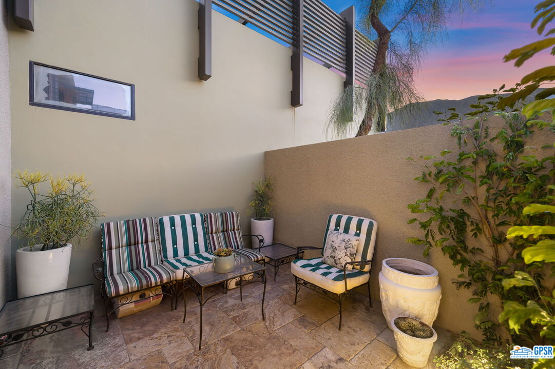 665 East Arenas Road Palm Springs, CA 92262 - Photo 19 of 40 a view of a chairs and table in backyard