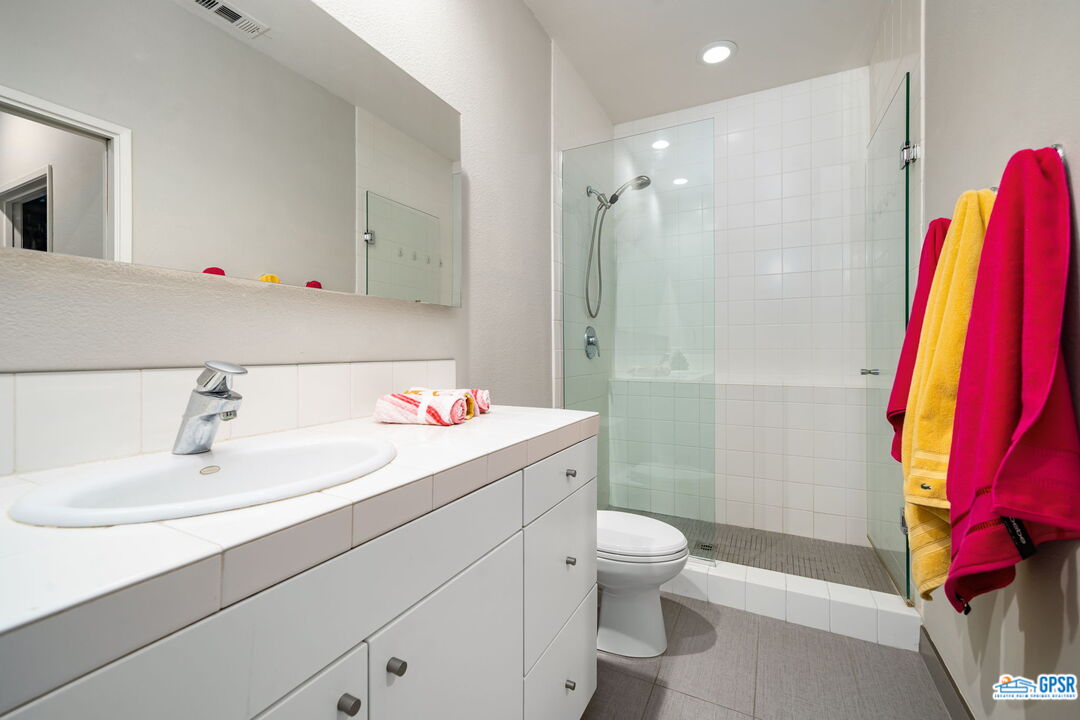 665 East Arenas Road Palm Springs, CA 92262 - Photo 30 of 40 a bathroom with a sink vanity mirror and toilet