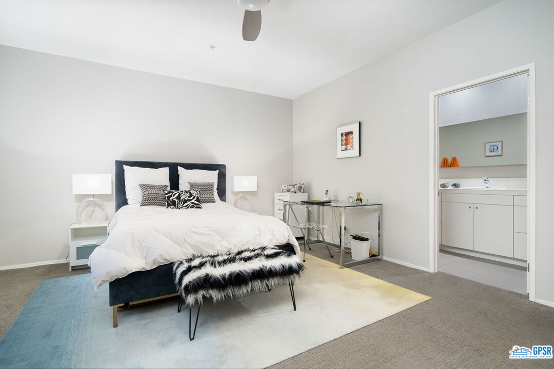 665 East Arenas Road Palm Springs, CA 92262 - Photo 31 of 40 a bedroom with a bed and a table in it