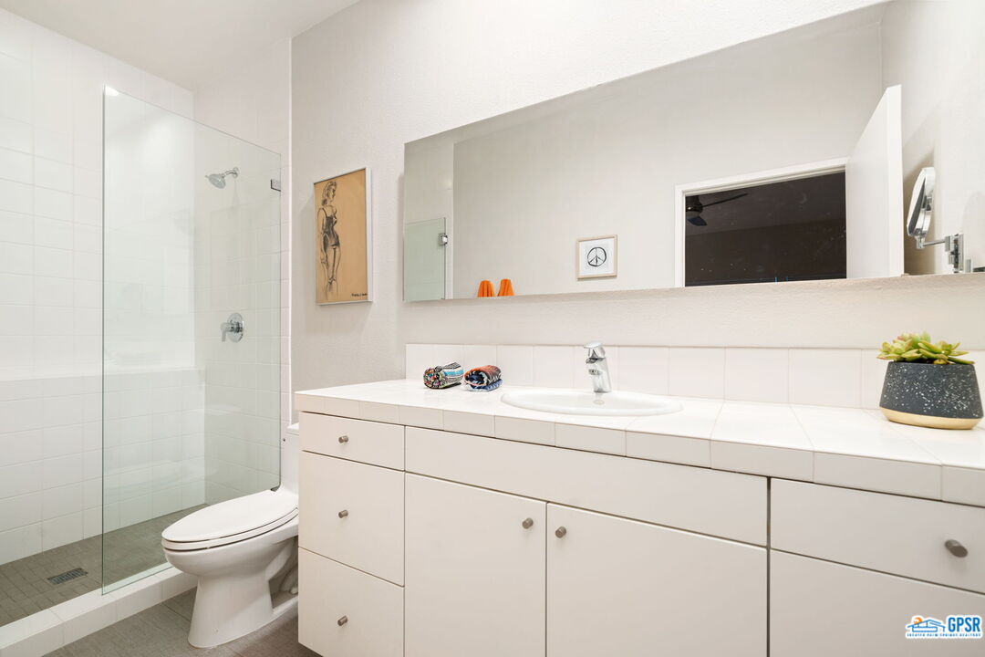665 East Arenas Road Palm Springs, CA 92262 - Photo 32 of 40 a bathroom with a toilet sink and mirror