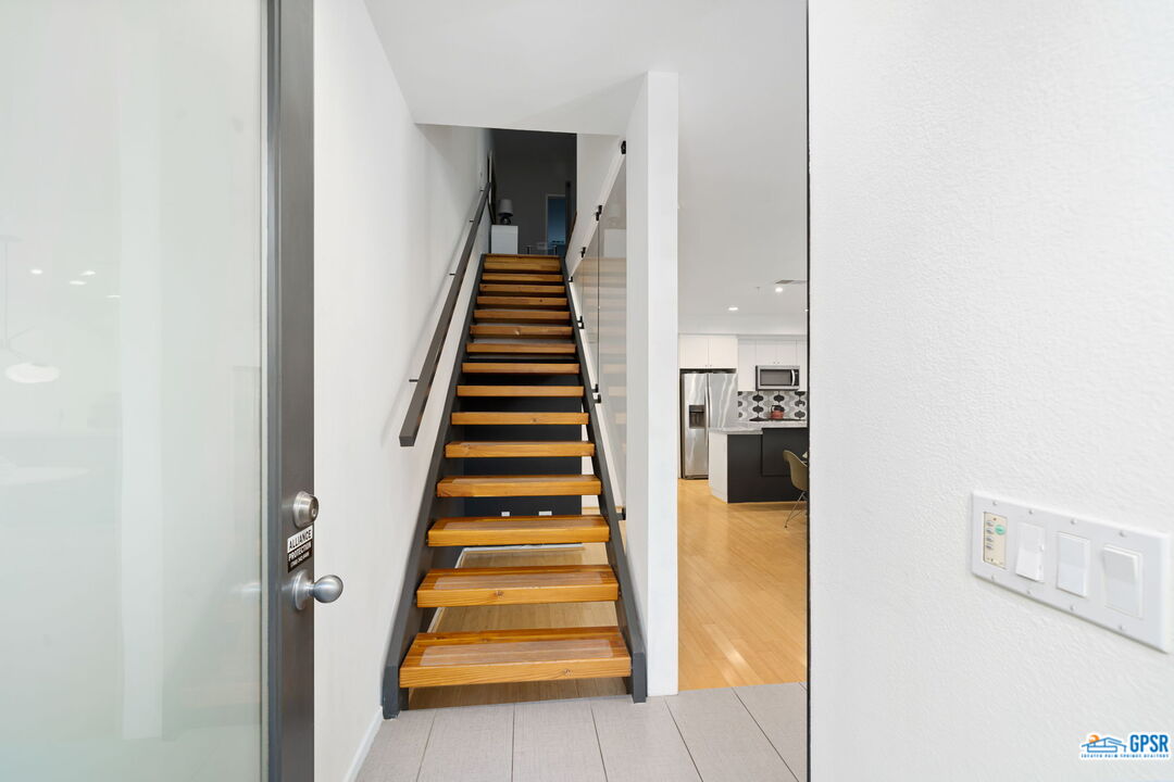 665 East Arenas Road Palm Springs, CA 92262 - Photo 6 of 40 a view of a hallway with wooden floor and entryway