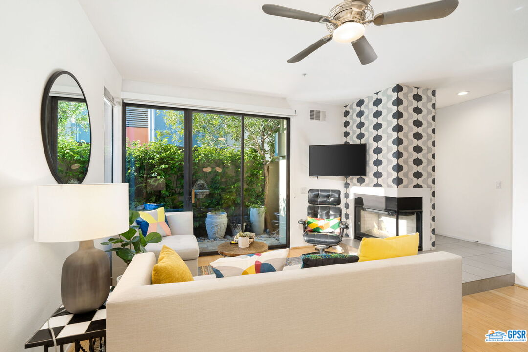 665 East Arenas Road Palm Springs, CA 92262 - Photo 9 of 40 a living room with furniture fireplace and flat screen tv