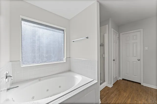 a bathroom with a tub shower and a sink