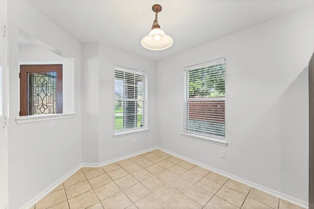 a view of an empty room with windows