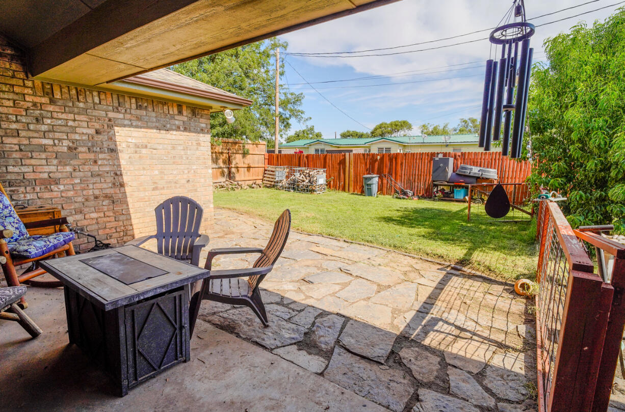 603 15th Street Shallowater, TX 79363 - Photo 17 of 18 a view of a patio with table and chairs potted plants with wooden floor and fence