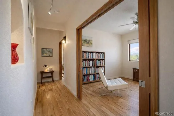a view of empty room with wooden floor and window