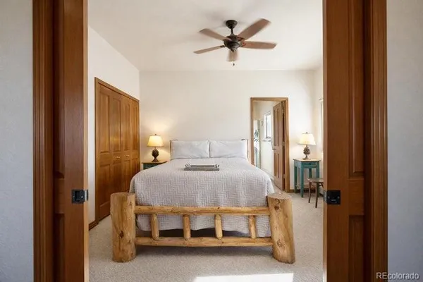 a bedroom with a bed and a chandelier