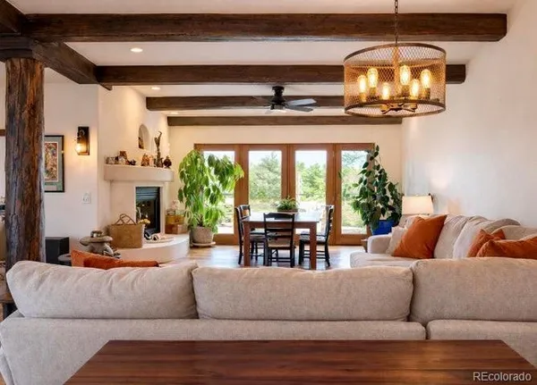 a living room with furniture and a large mirror
