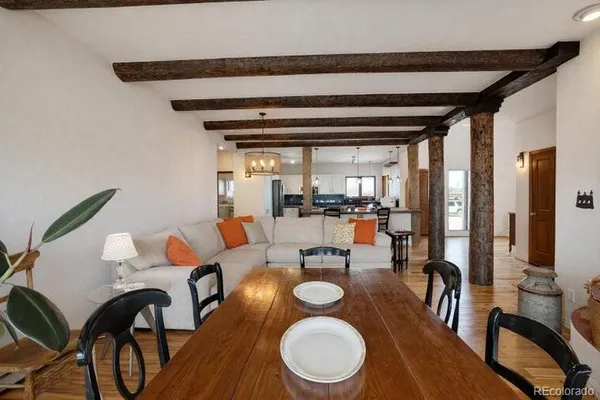 a dining room with furniture and wooden floor