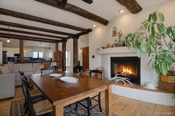 a view of a dining room with furniture and a potted plant