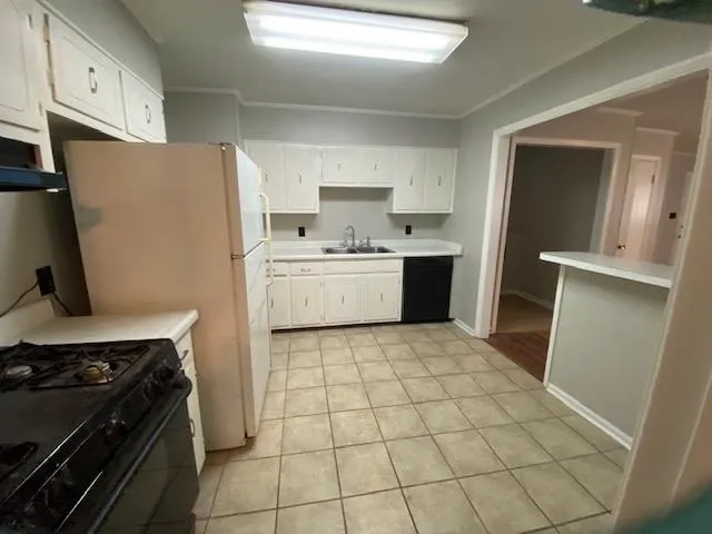 a room with washing machine and cabinets