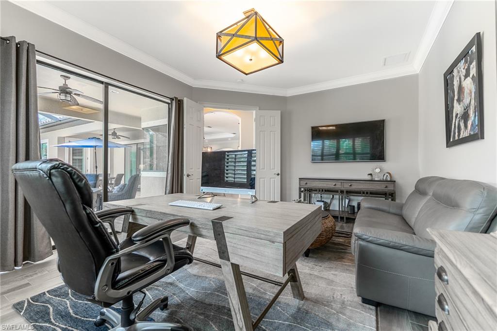 1387 Mockingbird Drive Naples, FL 34120 - Photo 18 of 46 a view of a livingroom with furniture and a flat screen tv