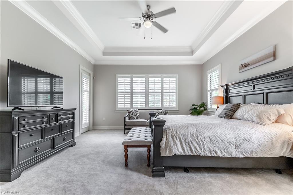 1387 Mockingbird Drive Naples, FL 34120 - Photo 19 of 46 a bedroom with a bed and dresser with mirror