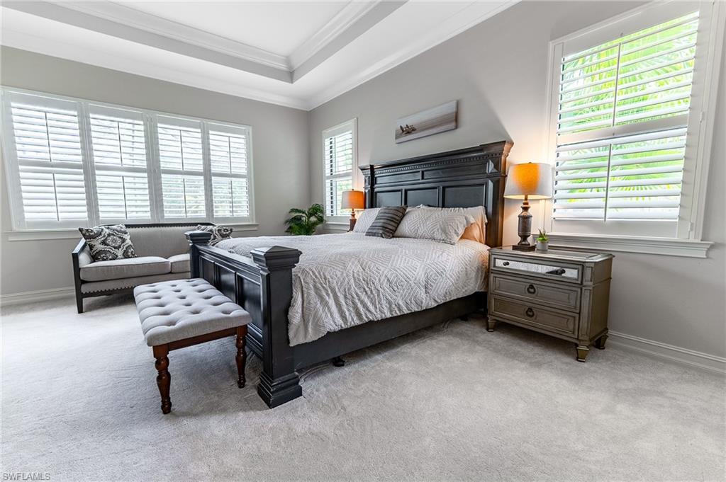 1387 Mockingbird Drive Naples, FL 34120 - Photo 20 of 46 a bedroom with a bed and a couch next to a window