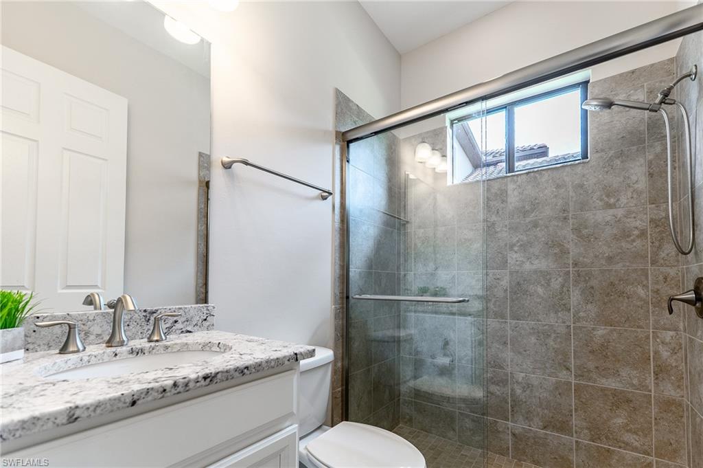 1387 Mockingbird Drive Naples, FL 34120 - Photo 30 of 46 a bathroom with a granite countertop sink toilet and shower