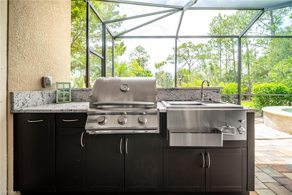 1387 Mockingbird Drive Naples, FL 34120 - Photo 33 of 46 a kitchen with a sink window and cabinets