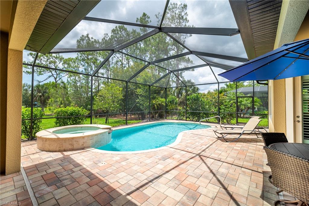 1387 Mockingbird Drive Naples, FL 34120 - Photo 36 of 46 a patio with a yard table and chairs