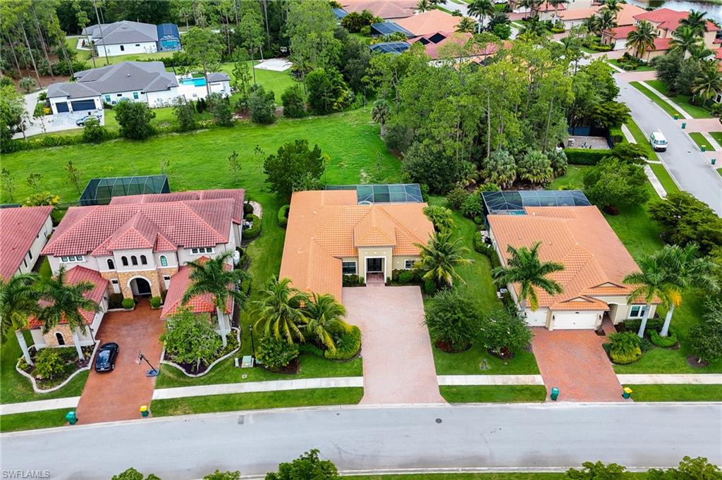 1387 Mockingbird Drive Naples, FL 34120 - Photo 43 of 46 a view of a garden with plants and large trees
