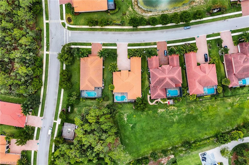 1387 Mockingbird Drive Naples, FL 34120 - Photo 46 of 46 an aerial view of a house with a yard and lake view
