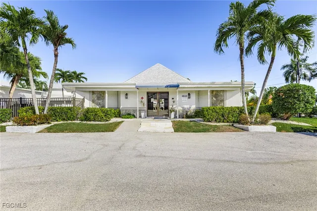 a front view of a house with a garden and yard