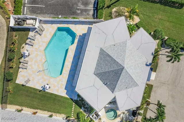 a view of a house with swimming pool and sitting area