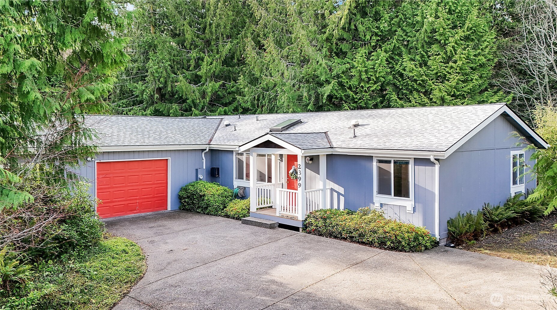 a aerial view of a house with a yard and garage