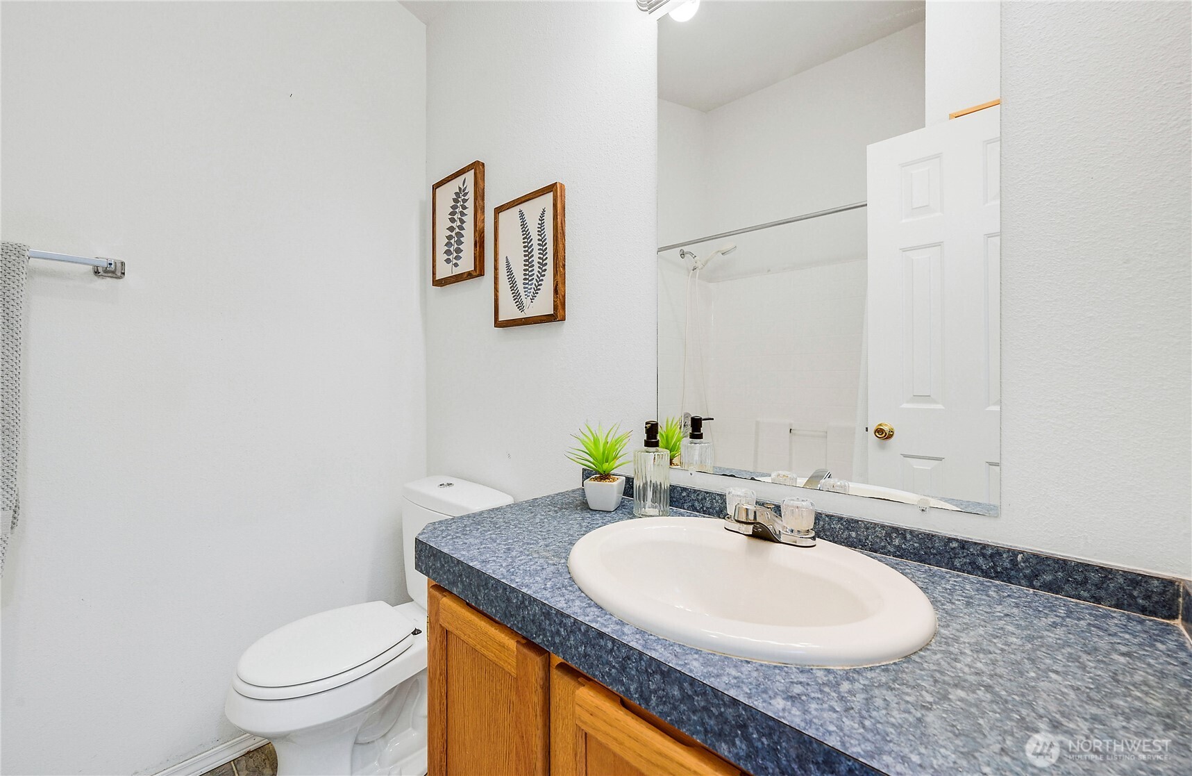 2399 Highland Loop Port Townsend, WA 98368 - Photo 14 of 31 a bathroom with a granite countertop sink a toilet and a mirror