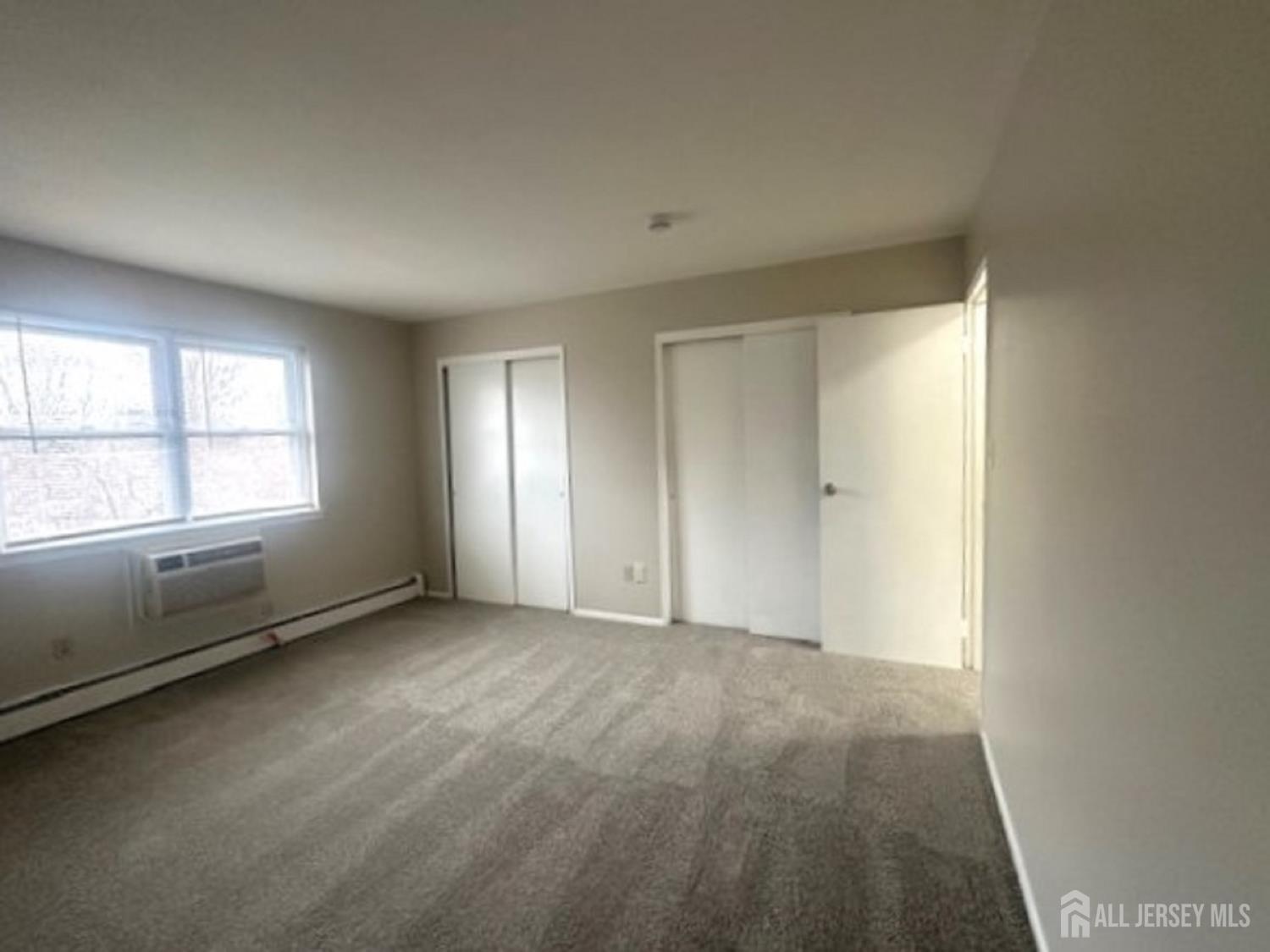 8 Manchester Court, Unit F Freehold, NJ 07728 - Photo 11 of 13 an empty room with windows