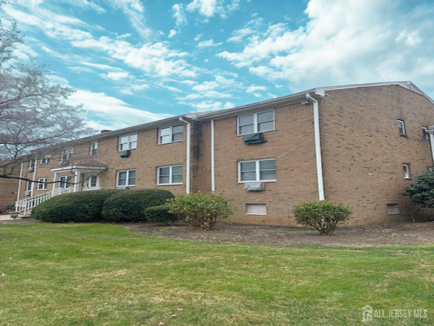 8 Manchester Court, Unit F Freehold, NJ 07728 - Photo 13 of 13 a front view of a house with garden