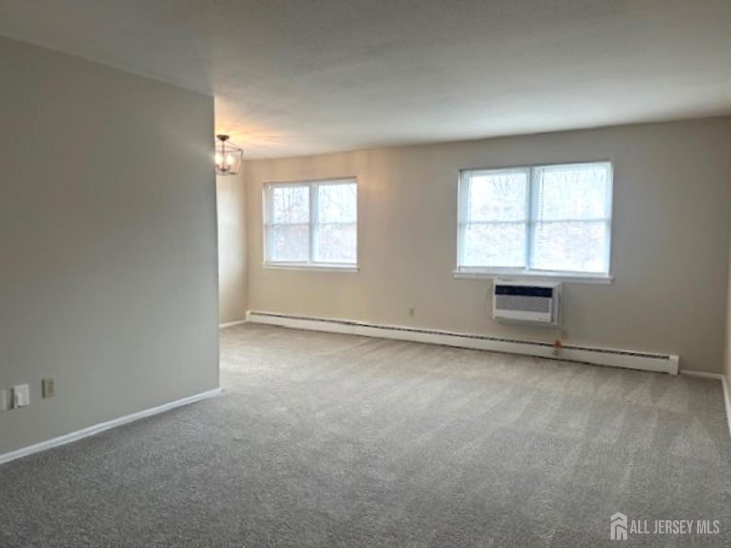 8 Manchester Court, Unit F Freehold, NJ 07728 - Photo 3 of 13 an empty room with windows