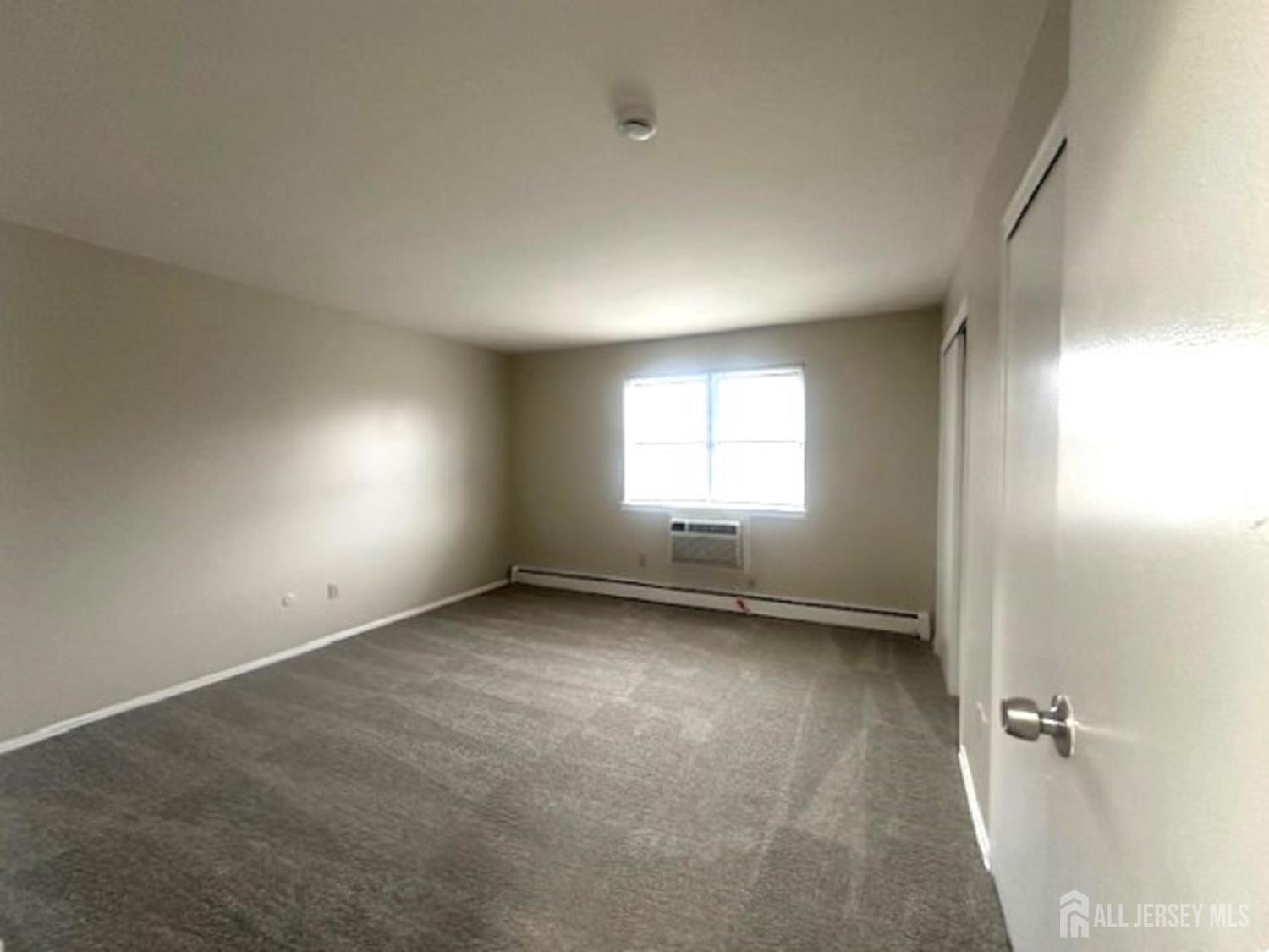 8 Manchester Court, Unit F Freehold, NJ 07728 - Photo 10 of 13 an empty room with a window