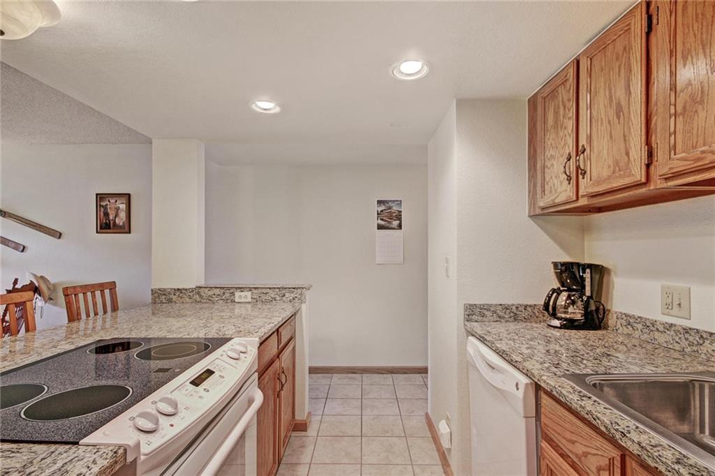 570 Bills Ranch Road, Unit 235 Frisco, CO 80443 - Photo 12 of 25 a kitchen with granite countertop a sink and a stove