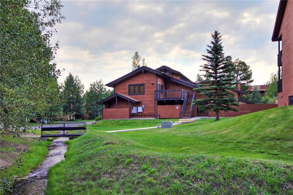 570 Bills Ranch Road, Unit 235 Frisco, CO 80443 - Photo 18 of 25 a view of a big house with a big yard and large trees
