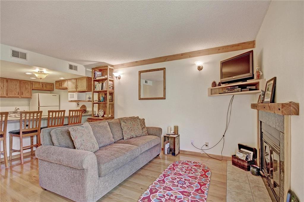 570 Bills Ranch Road, Unit 235 Frisco, CO 80443 - Photo 7 of 25 a living room with furniture and a flat screen tv