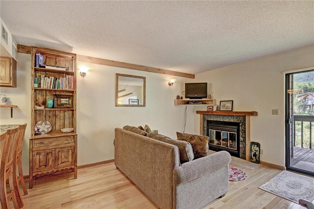 570 Bills Ranch Road, Unit 235 Frisco, CO 80443 - Photo 8 of 25 a living room with furniture and a flat screen tv