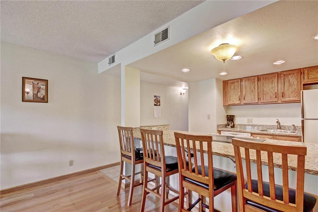 570 Bills Ranch Road, Unit 235 Frisco, CO 80443 - Photo 10 of 25 a view of a dining room with furniture and wooden floor