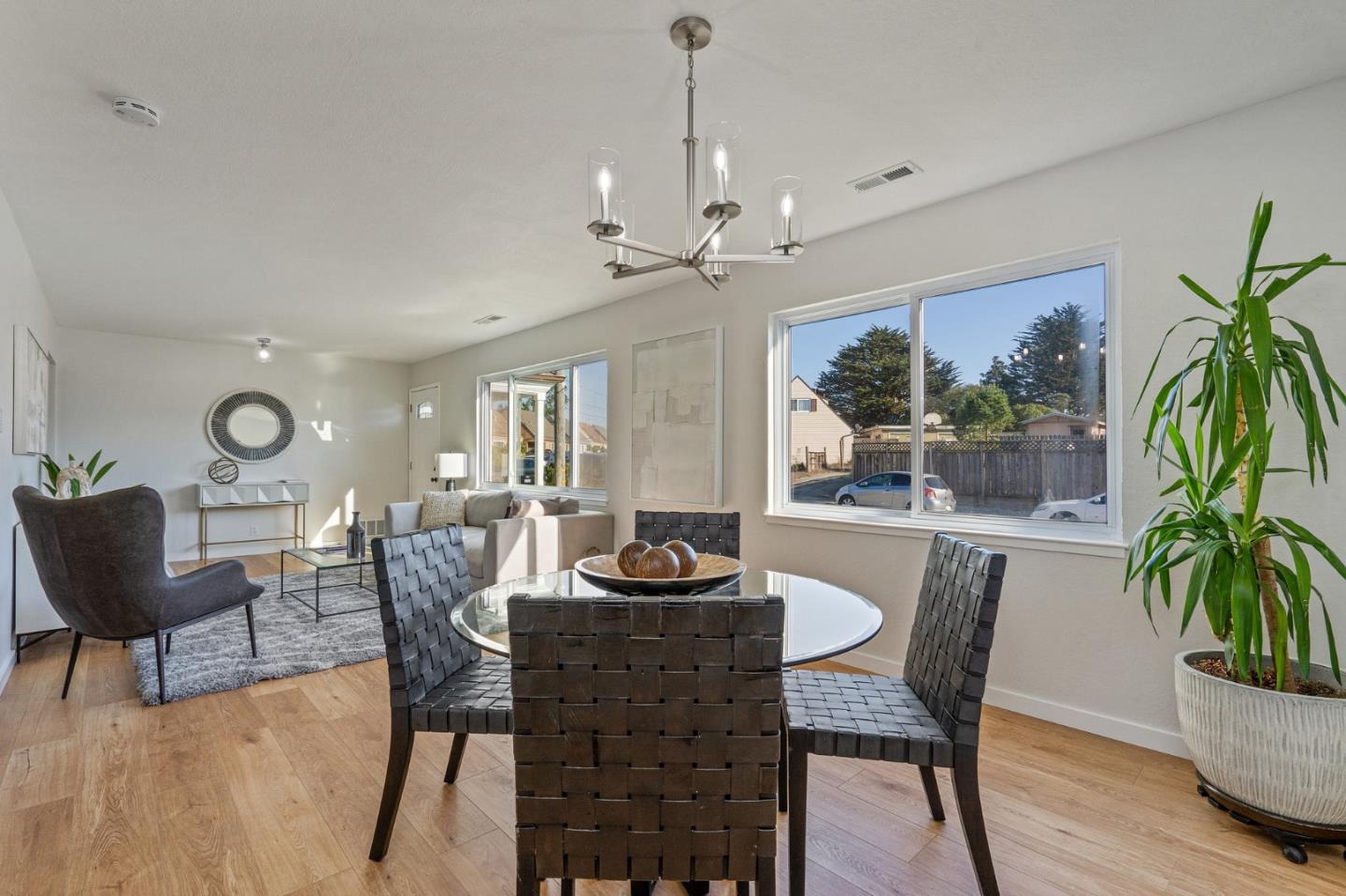 390 Heathcliff Drive Pacifica, CA 94044 - Photo 11 of 43 a dining room with furniture potted plants and wooden floor