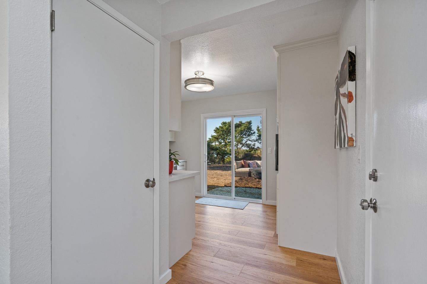 390 Heathcliff Drive Pacifica, CA 94044 - Photo 13 of 43 a view of a hallway view with wooden floor and dining room