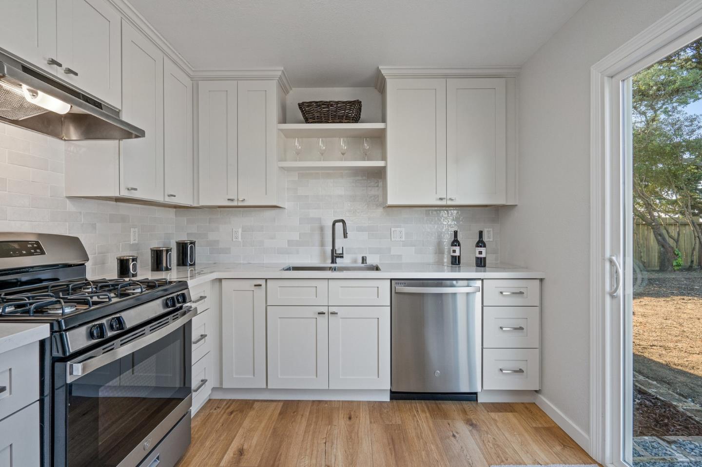 390 Heathcliff Drive Pacifica, CA 94044 - Photo 15 of 43 a kitchen with cabinets appliances and a wooden floor