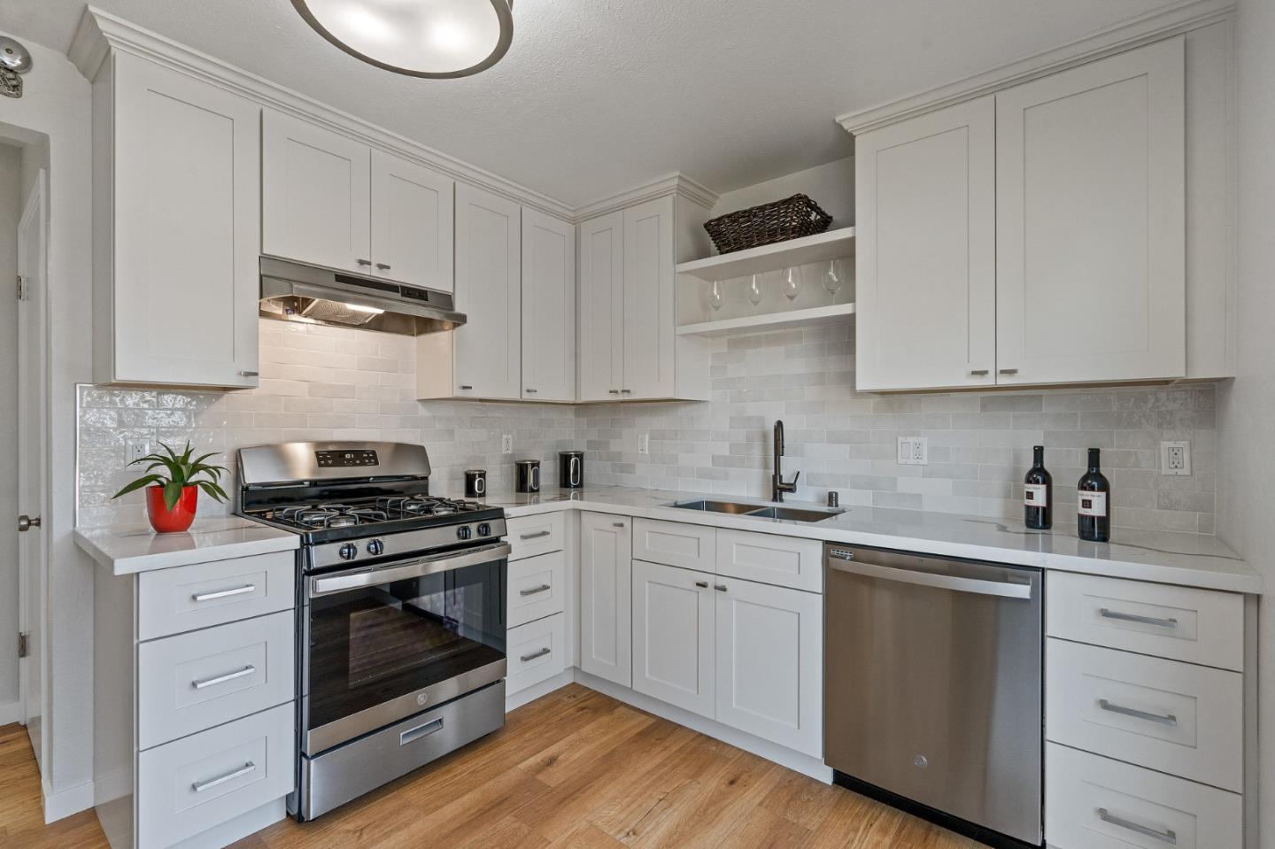 390 Heathcliff Drive Pacifica, CA 94044 - Photo 16 of 43 a kitchen with cabinets appliances and a wooden floor