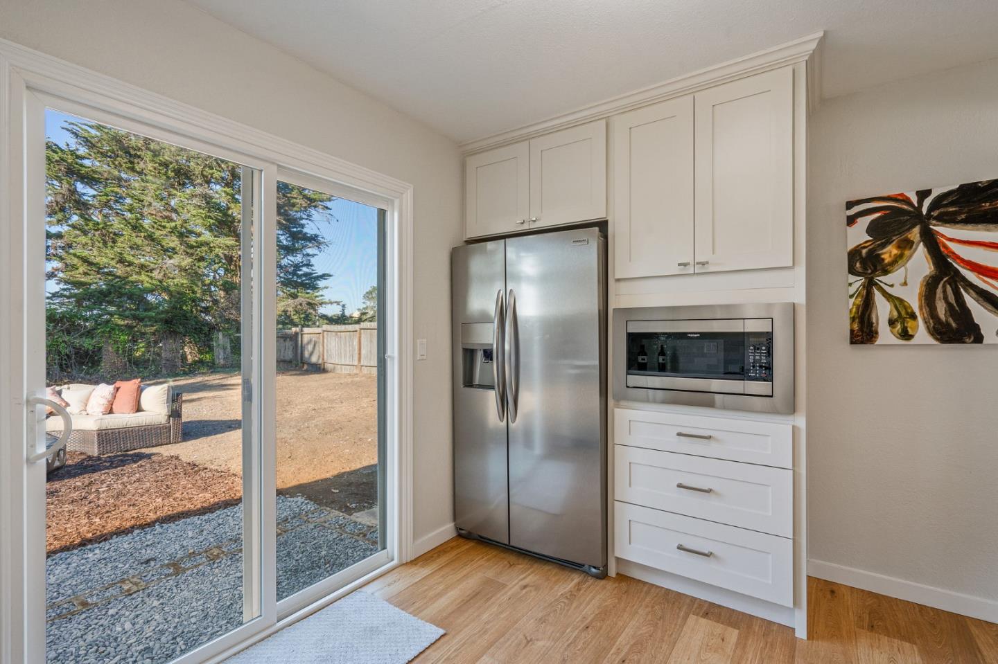 390 Heathcliff Drive Pacifica, CA 94044 - Photo 18 of 43 a kitchen with a refrigerator and white cabinets
