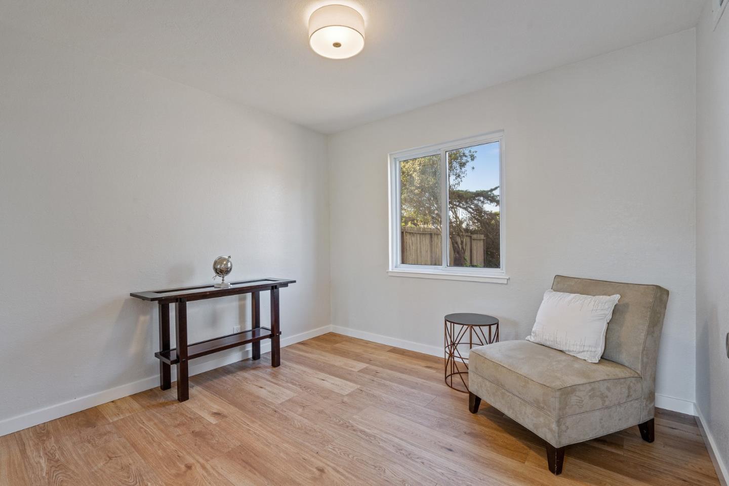 390 Heathcliff Drive Pacifica, CA 94044 - Photo 23 of 43 a living room with furniture and a wooden floor
