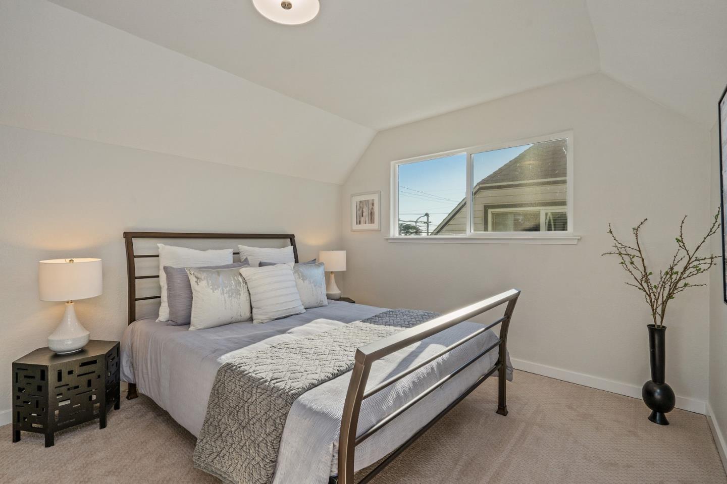 390 Heathcliff Drive Pacifica, CA 94044 - Photo 30 of 43 a bedroom with a bed and a night stand