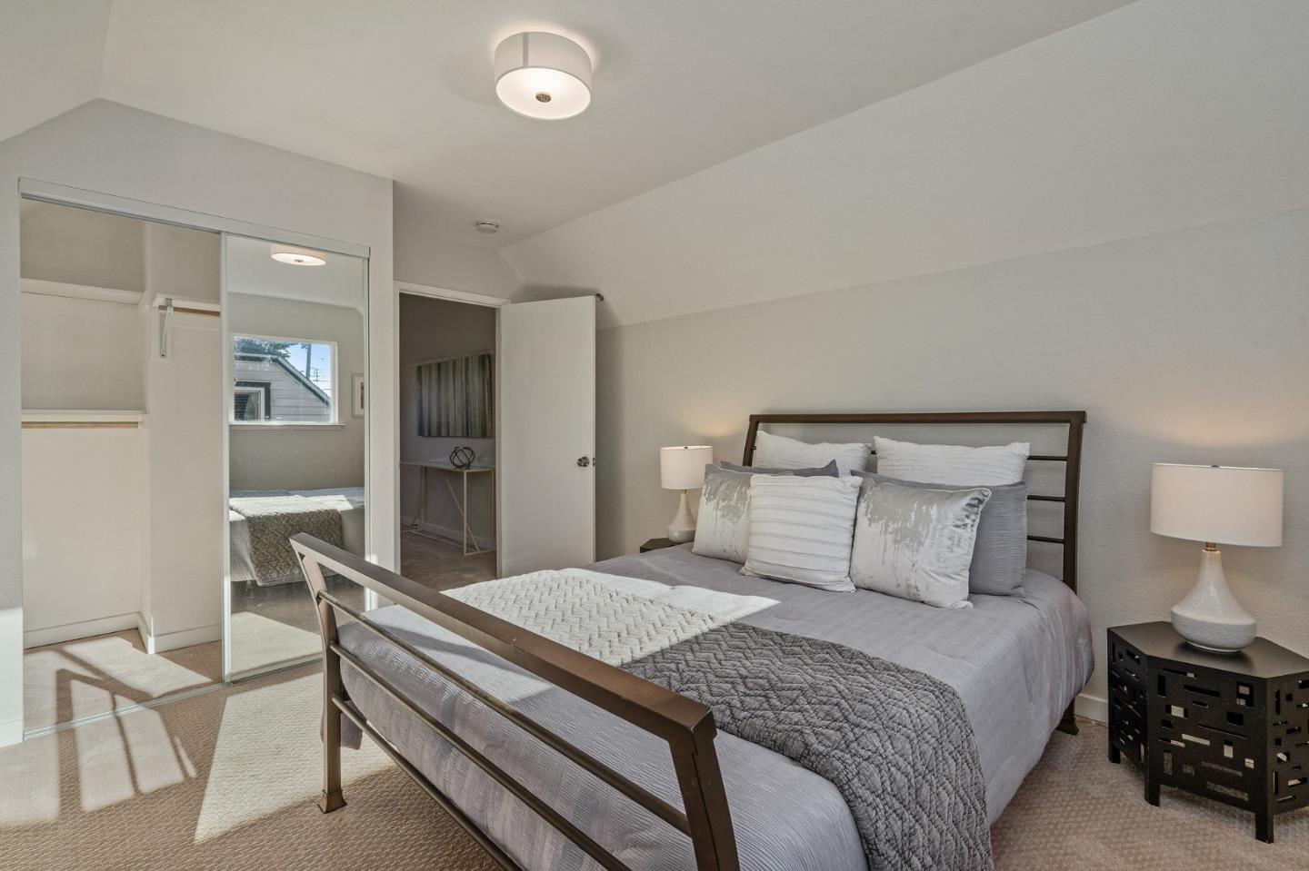 390 Heathcliff Drive Pacifica, CA 94044 - Photo 31 of 43 a bedroom with a bed and a lamp on table