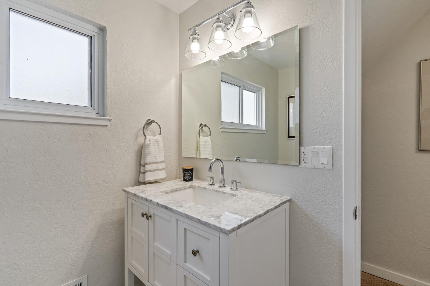 390 Heathcliff Drive Pacifica, CA 94044 - Photo 36 of 43 a bathroom with a sink and a mirror