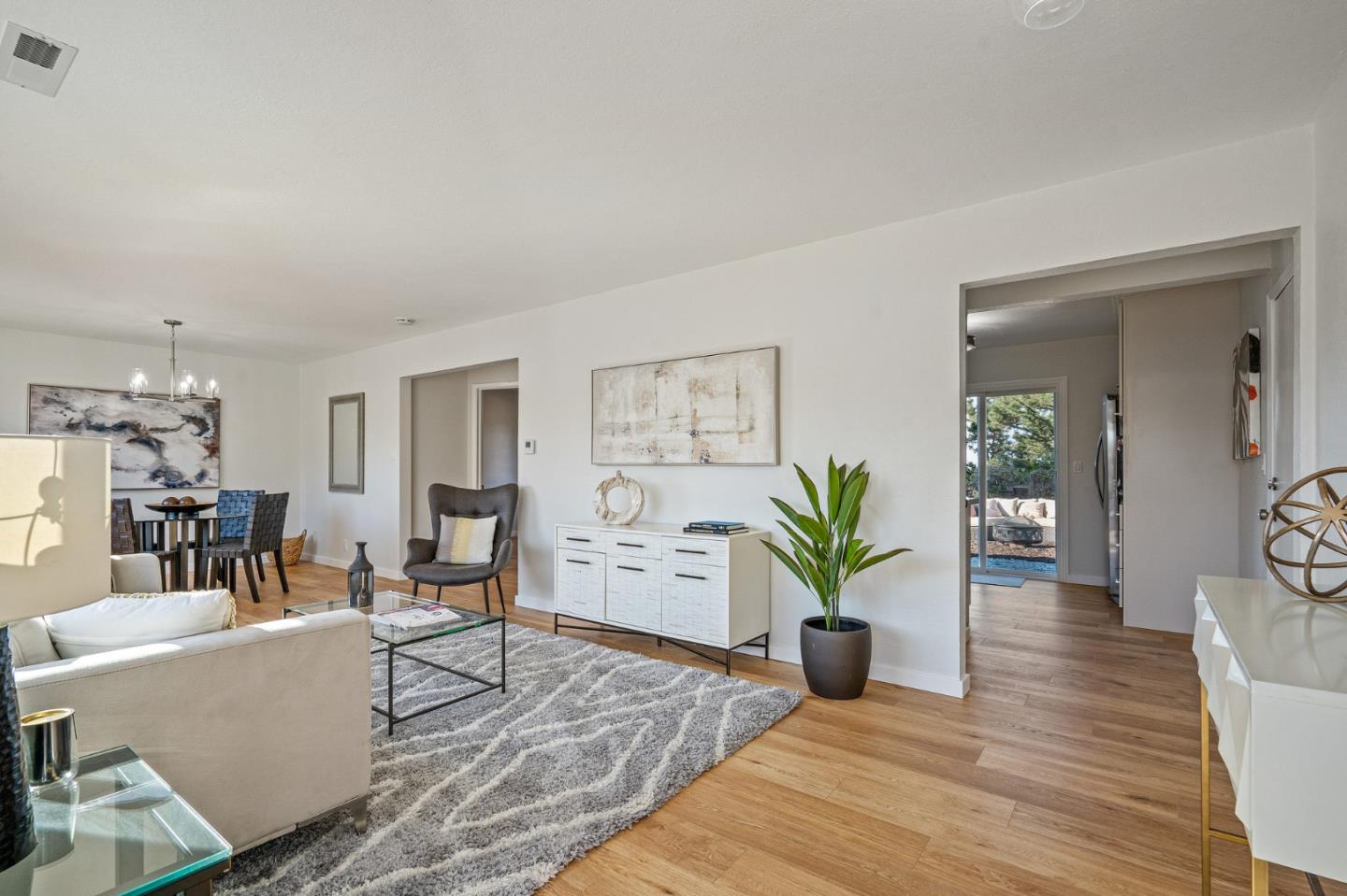 390 Heathcliff Drive Pacifica, CA 94044 - Photo 5 of 43 a living room with furniture a potted plant and kitchen view